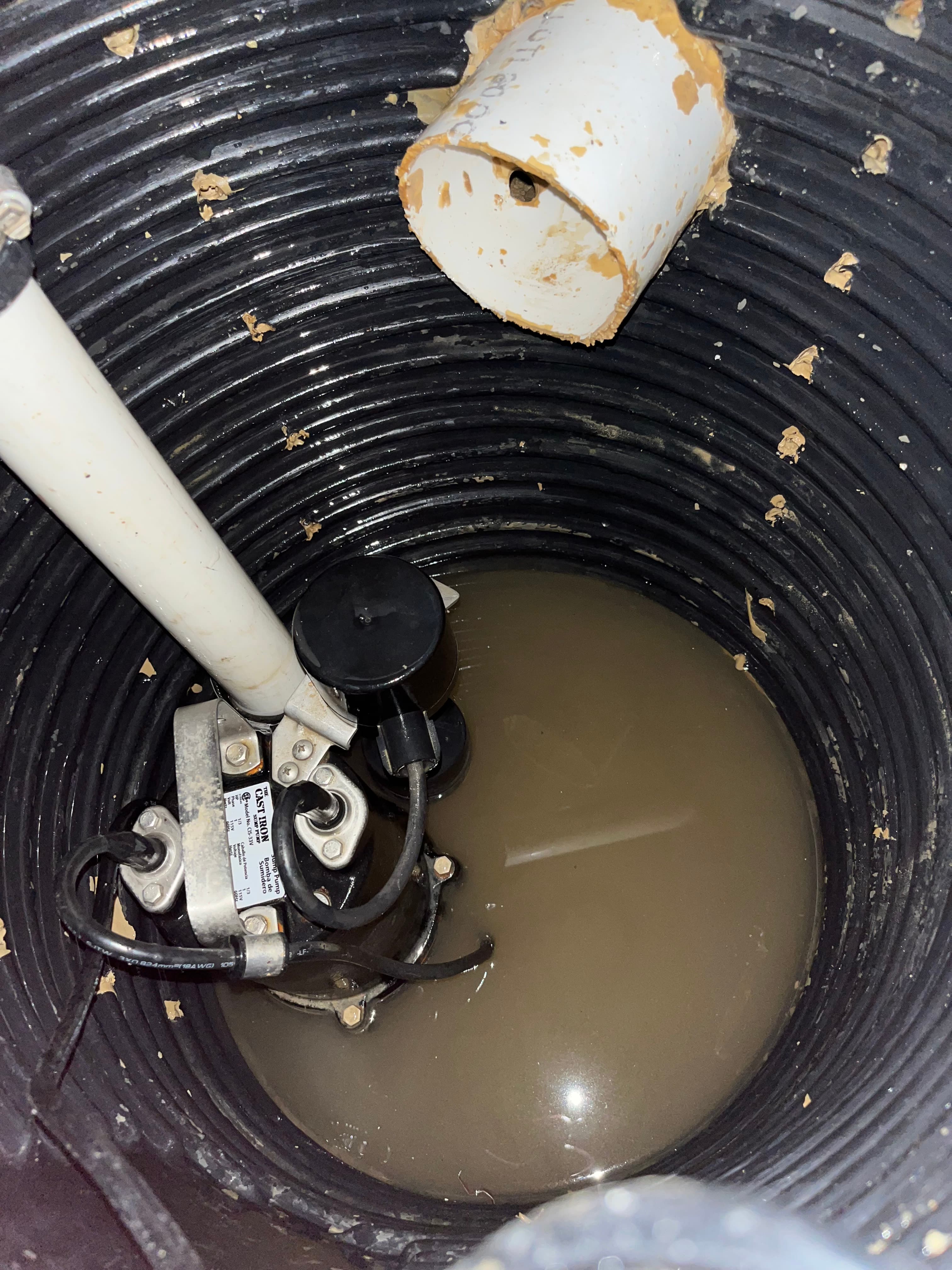 Close-up of black cast-iron pump with fresh PVC